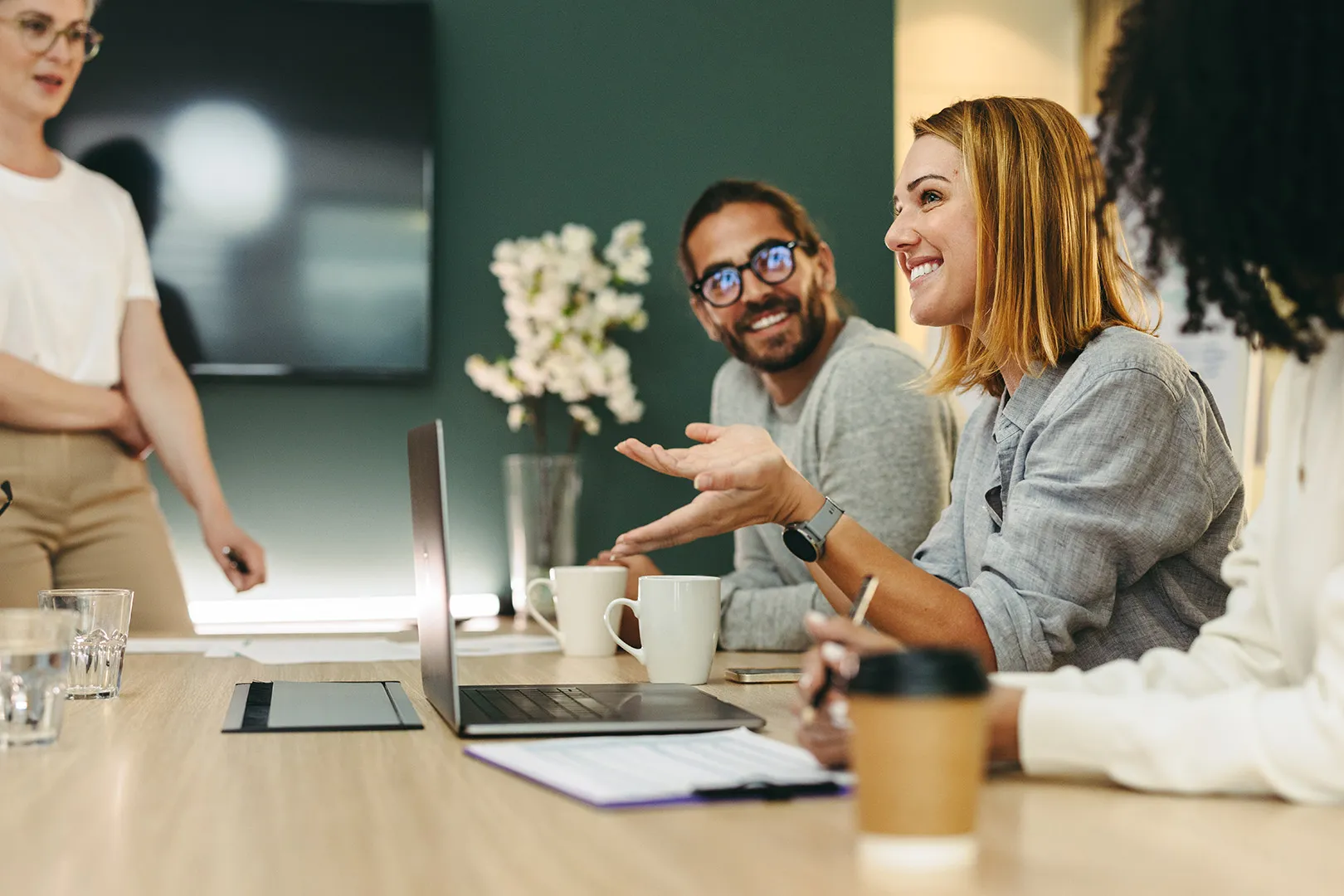 A group of people at a table working at their laptops