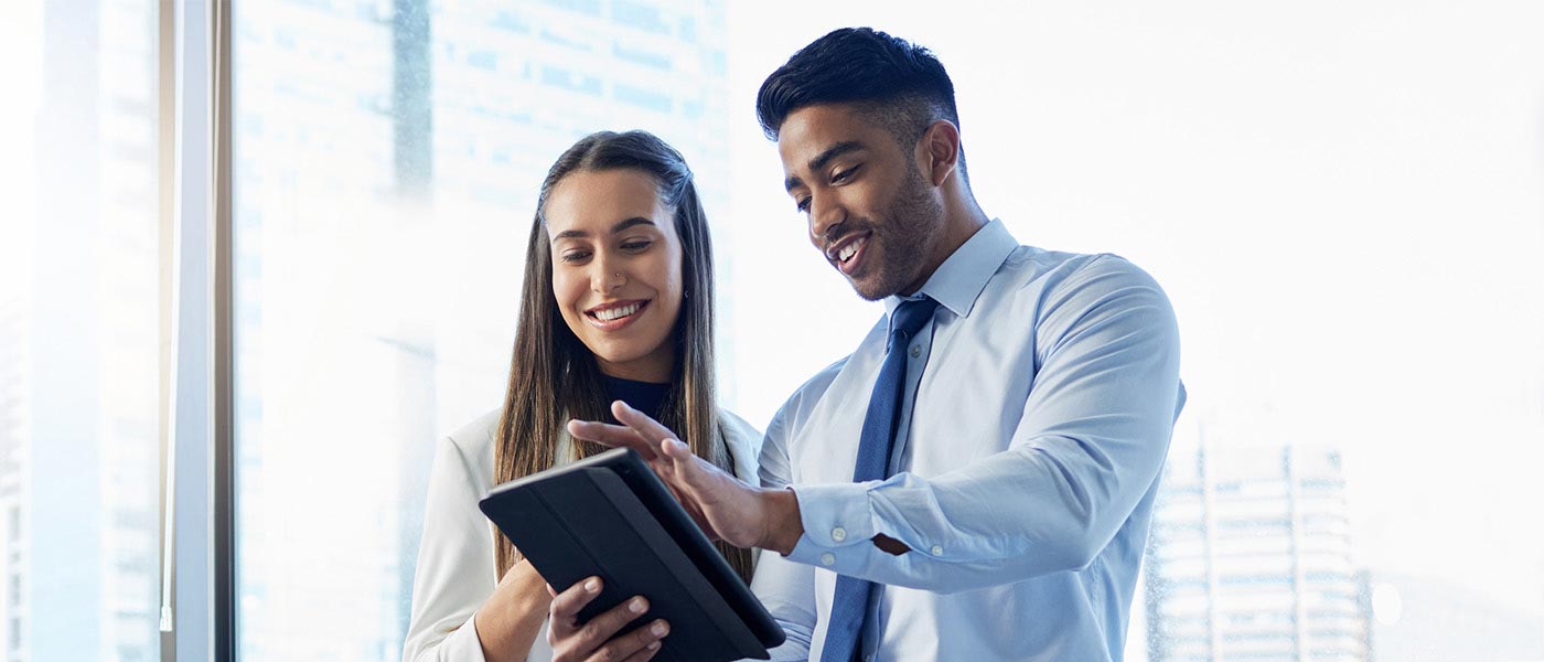 A man and woman interacting with a tablet computer