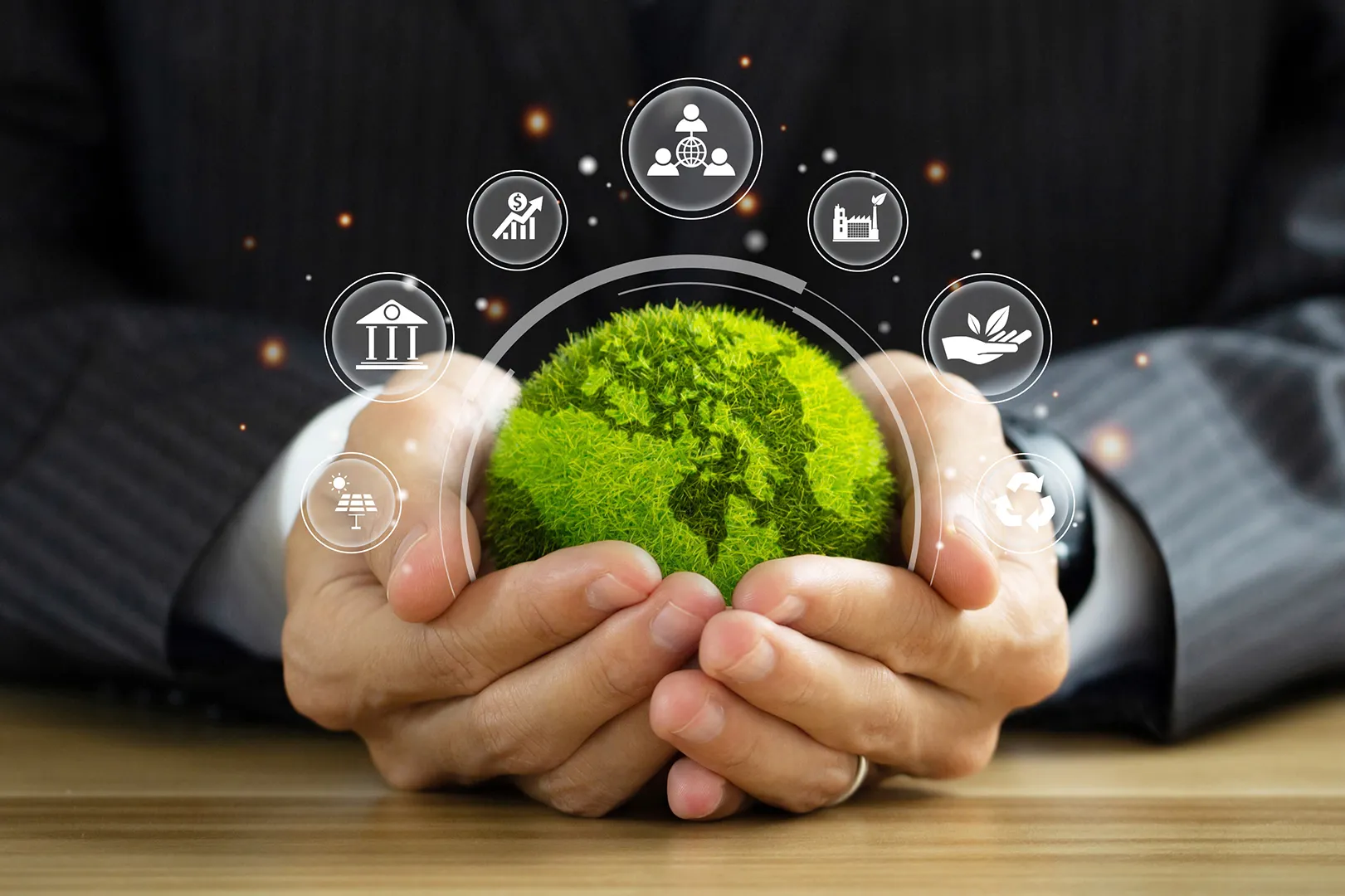 A pair of hands holding a green earth globe