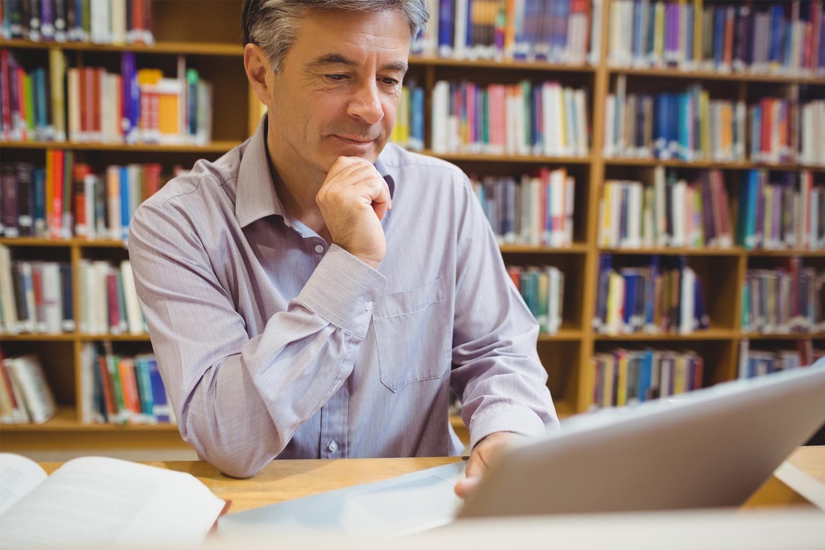 Man in a library reading