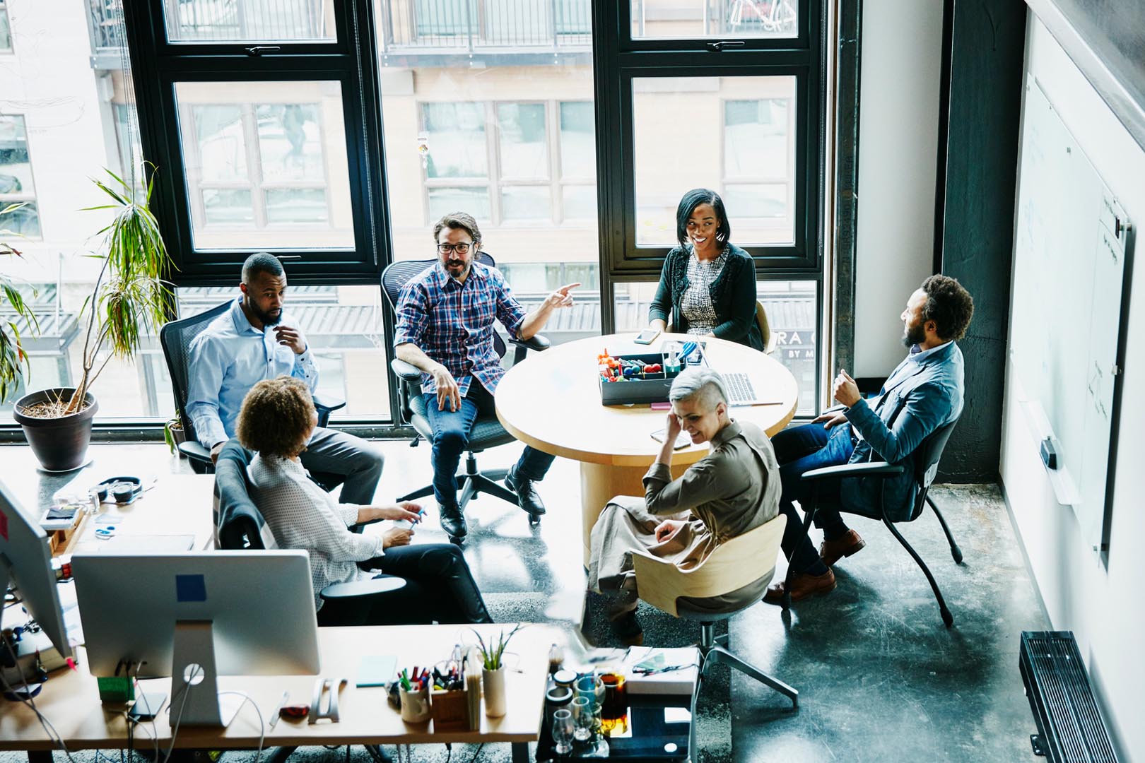 Employees sitting around a table in a meeting
