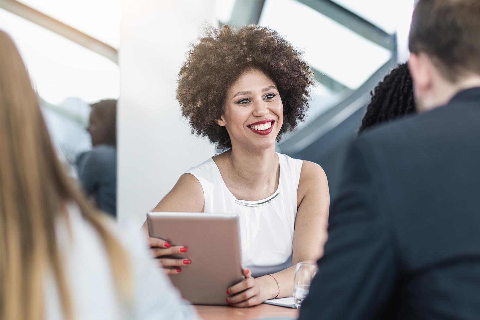 Women behind computer on tablet smiling