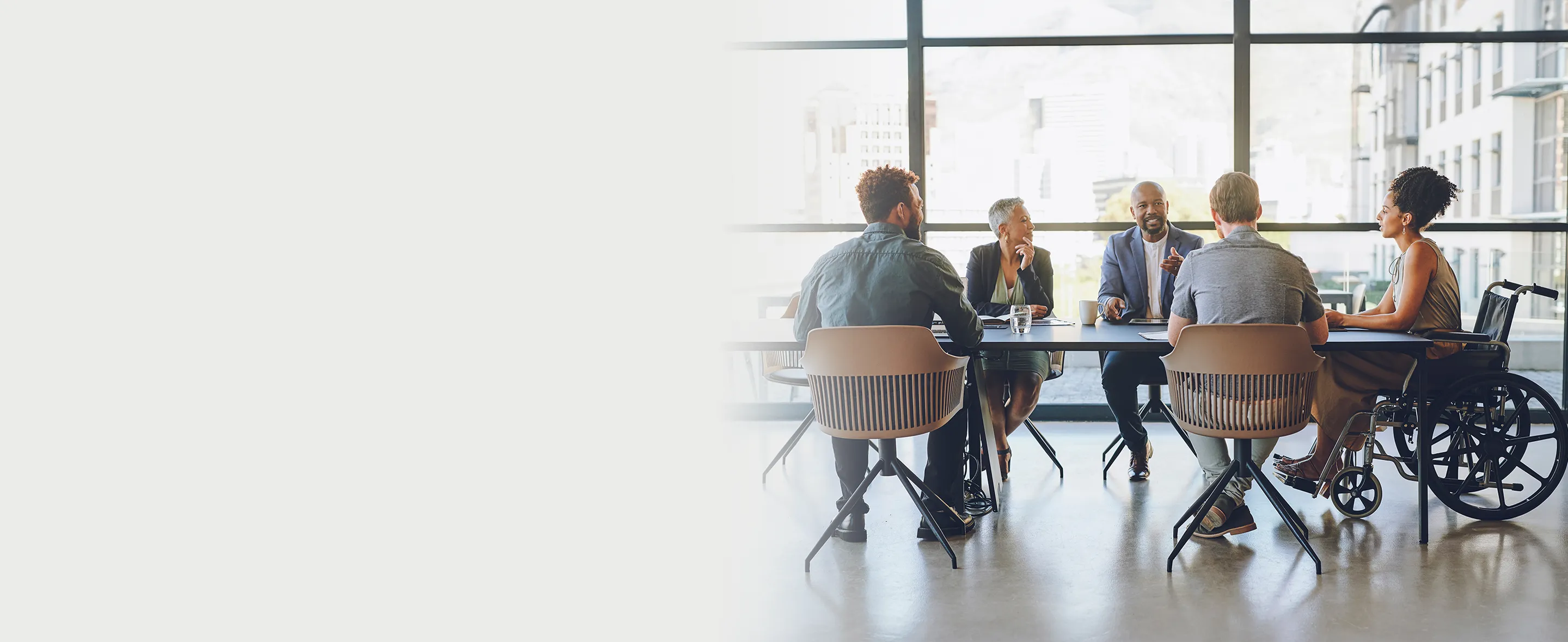 A group of people seated around a table having a discussion